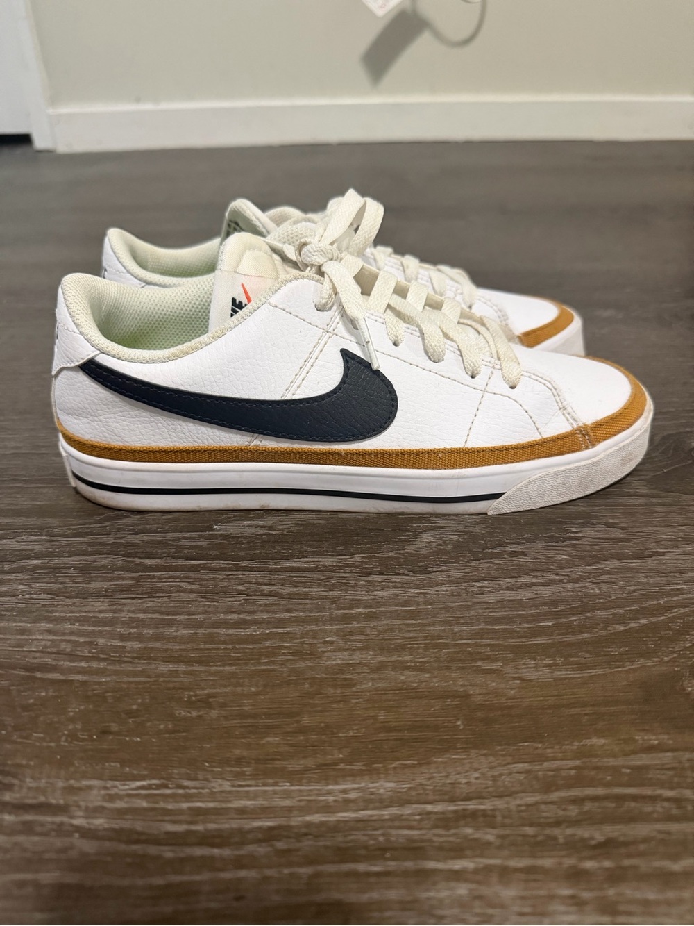 Nike women’s White Sneakers with Black Swoosh and Brown Trim